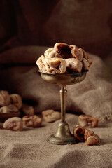 Dried figs in an old brass dish.