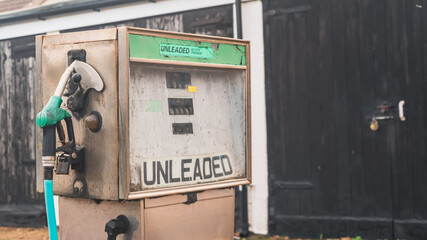 Vintage unleaded petrol pump on forecourt