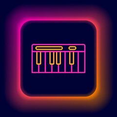 Glowing neon line Music synthesizer icon isolated on black background. Electronic piano. Colorful outline concept. Vector