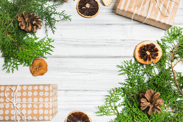 Christmas branches, gift boxes and dried fruits on white wooden table. Christmas background. Flat lay. top view with copy space- Image