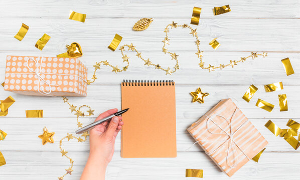  golden christmas decorations and notebook on white background. Flat lay, top view, copy space - Image - Powered by Adobe