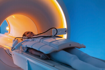Medical CT or MRI Scan with a patient in the modern hospital laboratory. Interior of radiography department. Technologically advanced equipment in white room. Magnetic resonance diagnostics machine - obrazy, fototapety, plakaty