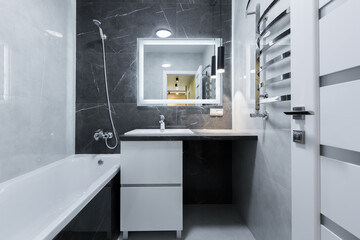 bathroom with black tile interior in a small apartment