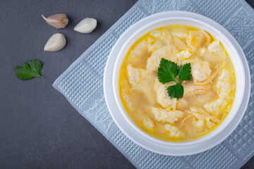 Soup with dumplings and meat on table, copy space
