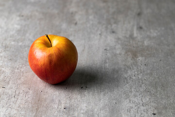 Apple in the center of a table with led light