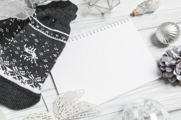 silver christmas decorations and notebook on white background. Flat lay, top view, copy space- Image
