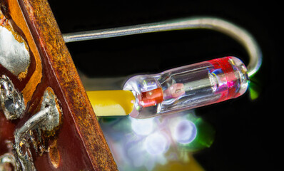 Vintage semiconductor germanium diode with crystal detector inside welded glass tube. Close-up of...