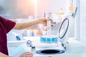 Laboratory assistant works with microwave hybrid tissue processor at the modern laboratory.