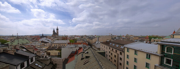 Krakow panorama above house roofs with cloudy sky - 471869015