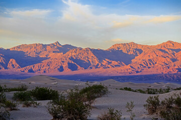 Sand dunes red cliffs near Death Valley at sunset - 471869017
