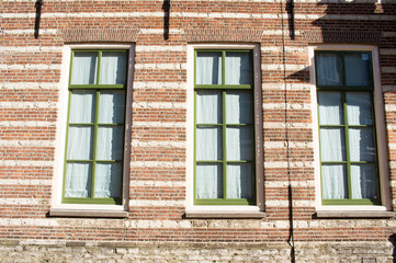 Fototapeta na wymiar Closeup of a wall with windows of a historic building in Utrecht in the Netherlands