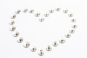 Heart Shape Heap of Metal Pushpin or Drawing Pin isolated on white