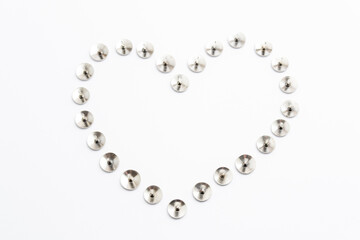 Heart Shape Heap of Metal Pushpin or Drawing Pin isolated on white