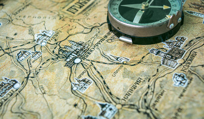 Photo of old vintage map on aged page with compass, retro
