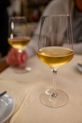 Dinner with sweet cold muscat white desert wine in traditional Italian osteria restaurant