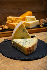 British cheeses collection, blue Stilton, Scottish coloured and English matured cheddar cheeses