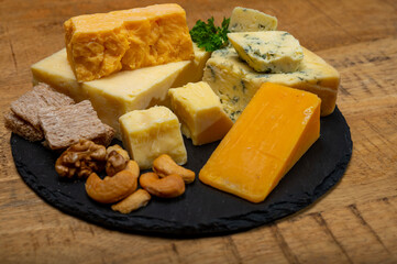 British cheeses collection, blue Stilton, Scottish coloured and English matured cheddar cheeses