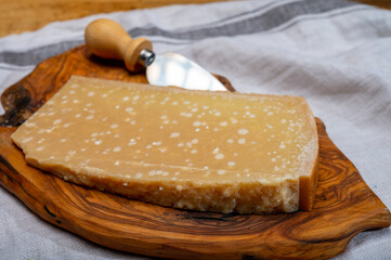 72 months very old Italian parmigiano-reggiano parmesan cheese from Parma has amber color, dry, extremely grainy and crumbly with very intense taste.