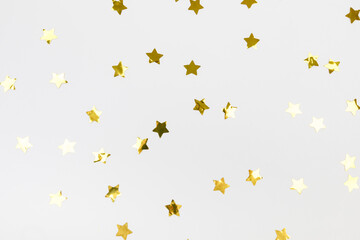 golden confetti on white background flat lay text place .