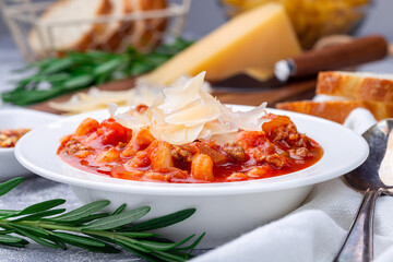 Minestrone soup with cavatappi pasta, beans and vegetables, served with crispy bread, horizontal