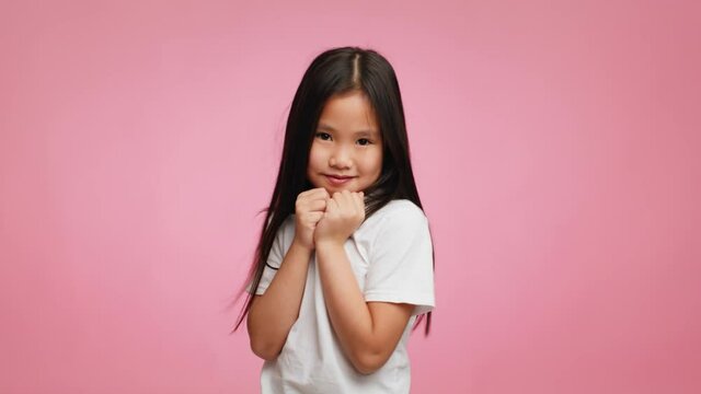Shy Japanese Little Girl Posing Over Pink Background