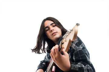 Teenager playing the guitar shaking his head.