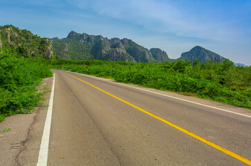 Long road with trees on roadside ,Empty asphalt road and natural landscape under the blue sky 