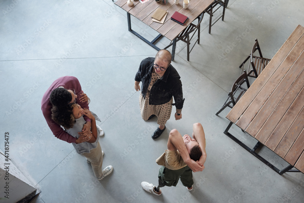 Poster Overview of happy co-workers enjoying break while two of them embracing, man with leg prosthesis exercising and young female looking at him
