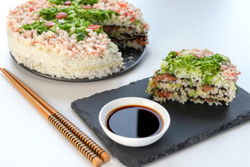 California sushi casserole. Handmade homework. Soy sauce on the table.