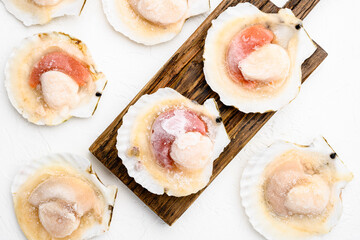 Scallop. Frozen meat scallop shells, on white stone table background, top view flat lay