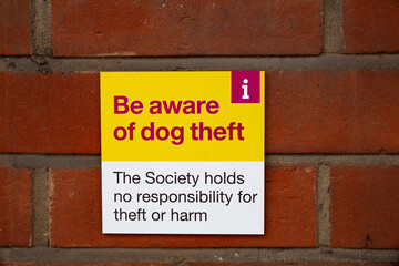 'Be aware of dog theft' sign outside of a supermarket informing the public they arent responsible...