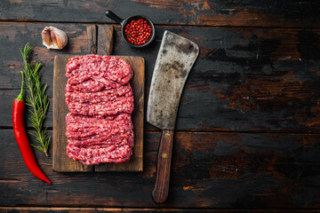 Minced meat, on old dark  wooden table background, top view flat lay  with copy space for text