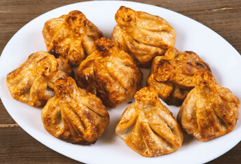 Fried khinkali in a white plate.Georgian cuisine.