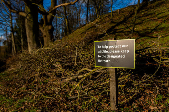 'To help protect our wildlife, please keep to designated footpath' sign in the Suffolk countryside