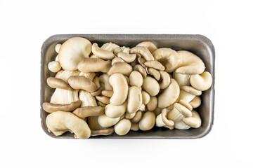 Fresh oyster mushrooms also know as Pleurotus ostreatus in a package made of polystyrene foam material, isolated on a white background. A product for vegetarians