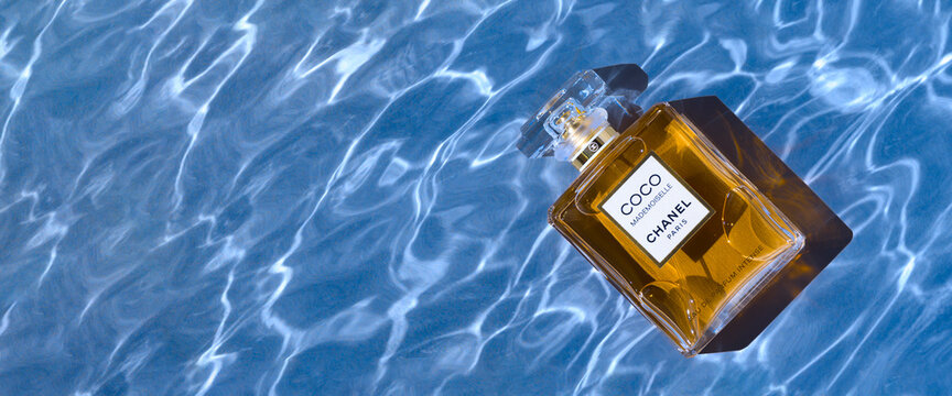 A bottle of Chanel perfume on the background of the texture of water, with a beautiful shadow with highlights. Coco Chanel women's perfume series. 2020-07-05 Samara.