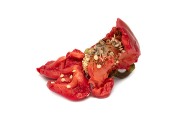Pieces of broken red bell pepper on a white background.