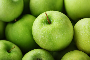 Background of ripe and juicy green apples, perspective from above.