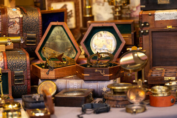 collection of antique and vintage objects for sale, clocks, books compass, Exeter Christmas market Devon UK November 21 2021