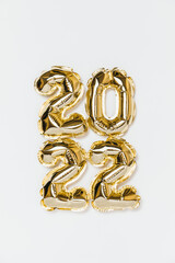 New year 2022 balloon celebration card. Gold foil helium balloon number 2022 isolated on white background. Flat lay, merry christmas, happy holidays mockup.
