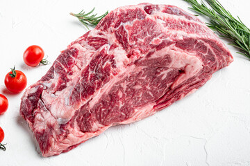 Sirloin beef meat marbled steak, Rib eye cut, on white stone  background