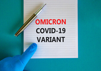 New covid-19 omicron variant strain symbol. Hand in blue glove with white note. Concept words Omicron covid-19 variant. Metalic pen. Medical and COVID-19 omicron variant strain concept. Copy space.