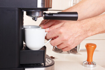 Barista makes two cups of espresso in coffee machine