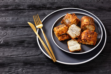 fried pieces of hake on a plate