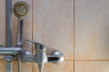 Shower tap. Heavy pollution from tap water. Yellow plaque from high iron content in the water....