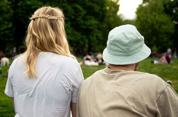 Back of young couple's heads in park on summer day