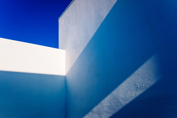 White walls geometric angled shapes of simple and clean design in sunny Mediterranean-style houses.