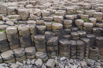 Bushmills, Northern Ireland: people close up view of the basalt columns of the Giant's Causeway