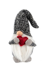 Handmade elf toy dressed in gray knitted cap with red heart in hands isolated on white background.