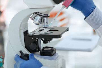 close up. scientist using an automatic dispenser during his research